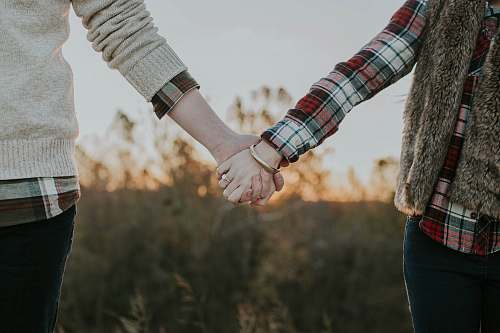 holding hands two person holding hands while standing couple